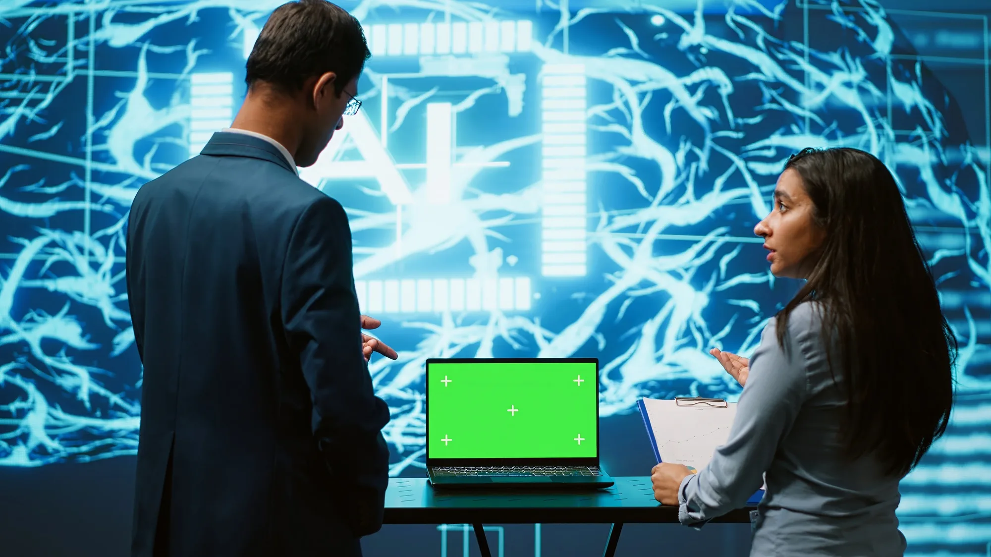 AI Marketing For Local Business 14 Startup coworkers looking over charts, using AI software on mockup laptop